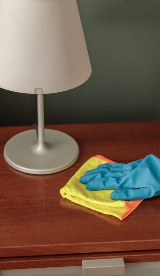 Made hand wiping dust off furniture. General or regular cleanup in room. High quality photo